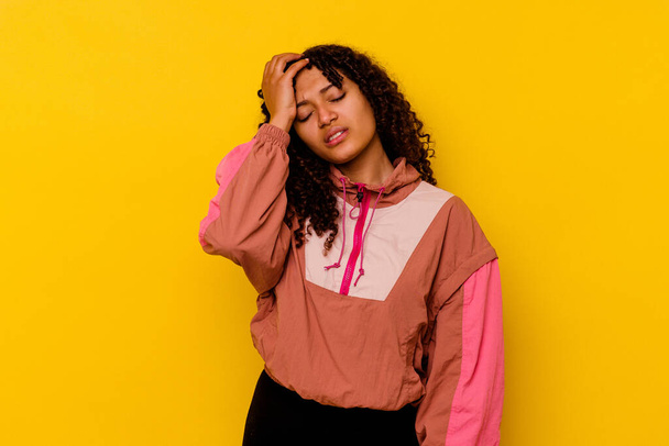 Young mixed race woman isolated on pink background tired and very sleepy keeping hand on head. - Фото, зображення