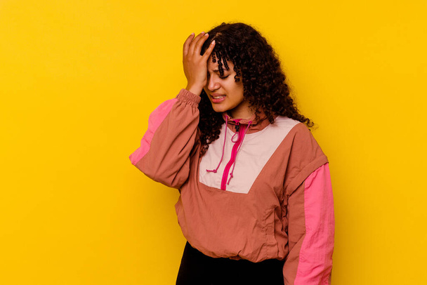 Young mixed race woman isolated on pink background forgetting something, slapping forehead with palm and closing eyes. - Photo, image