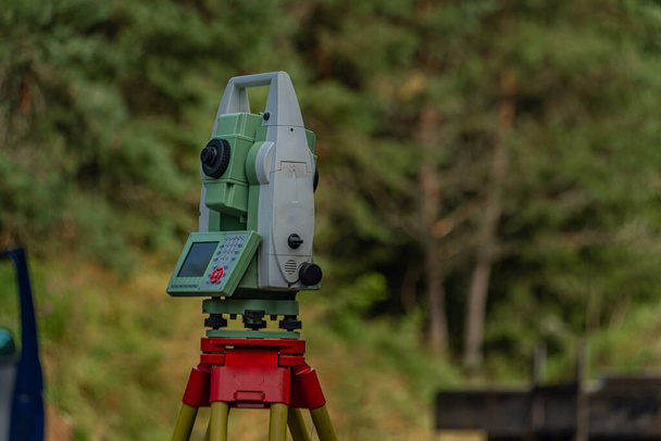 Machine for surveyors with blue sky and green trees in sunny color day - Photo, Image