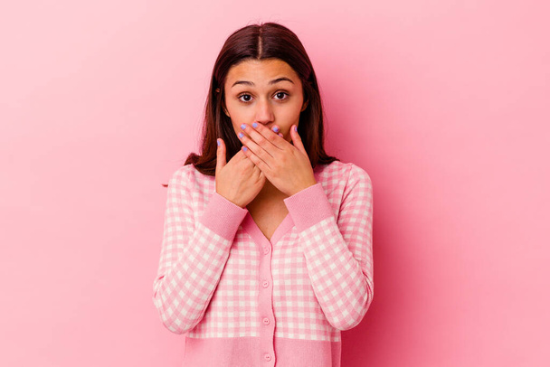 Young Indian woman isolated on pink background shocked covering mouth with hands. - Valokuva, kuva