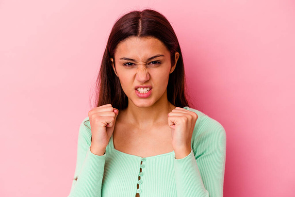 Young Indian woman isolated on pink background upset screaming with tense hands. - Fotoğraf, Görsel