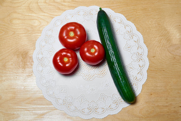 fresh tomatoes and cucumbers on a wooden background. Salad ingredients, Healthy food, Vegetarian food - Foto, immagini