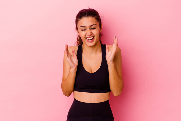 Young sport Indian woman isolated on pink background joyful laughing a lot. Happiness concept. - Fotoğraf, Görsel