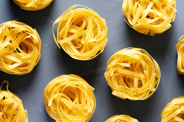 Nests of fettuccine pasta. - 写真・画像