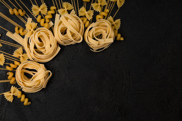 Types of pasta on a black background - Photo, Image