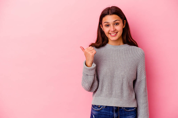 Young Indian woman isolated on pink background shocked pointing with index fingers to a copy space. - Photo, Image