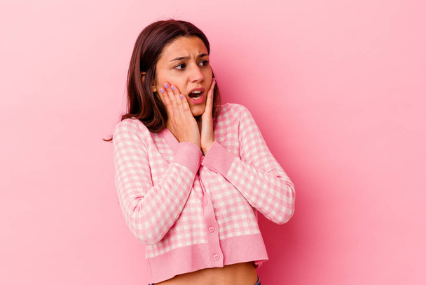 Young Indian woman isolated on pink background scared and afraid. - Valokuva, kuva
