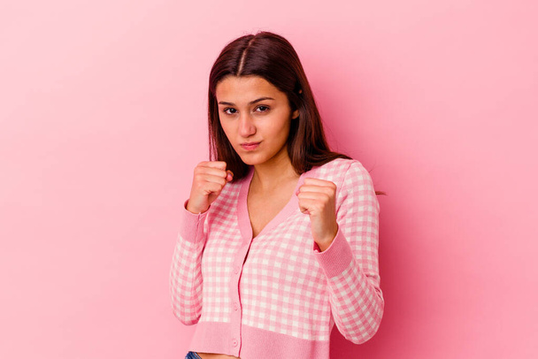 Young Indian woman isolated on pink background showing fist to camera, aggressive facial expression. - Photo, Image