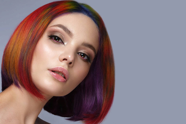 Beautiful woman with multi-colored hair and creative make up and hairstyle. Beauty face. - Photo, image