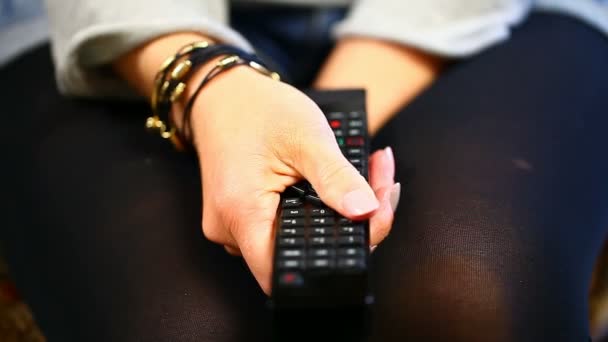 Woman with remote control in hand - Footage, Video