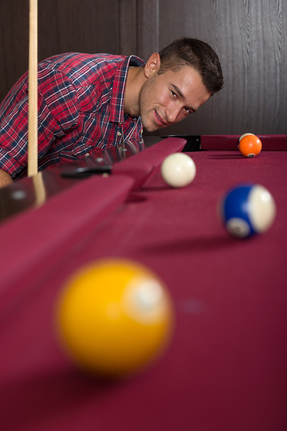 Young man playing billiard - Фото, зображення