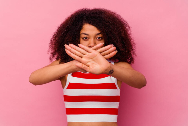 Young african american woman isolated on pink background doing a denial gesture - Foto, imagen