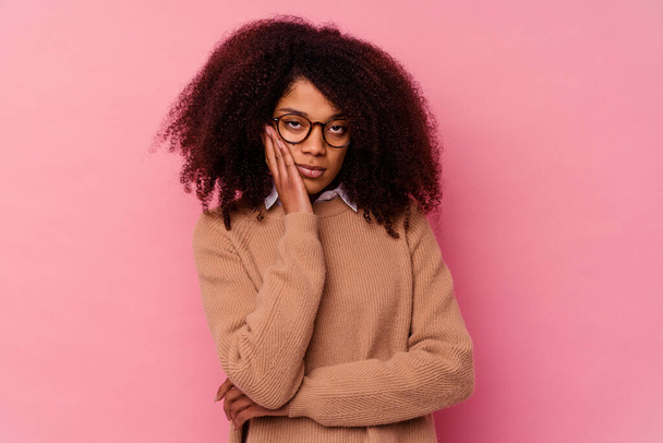 Young african american woman isolated on pink background who is bored, fatigued and need a relax day. - Photo, Image