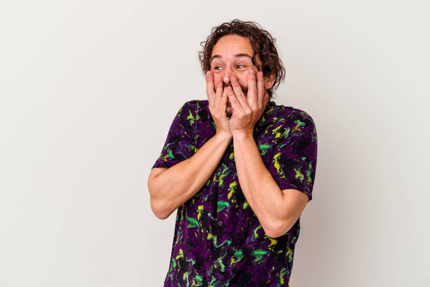 Young caucasian man isolated on white background laughing about something, covering mouth with hands. - Photo, Image