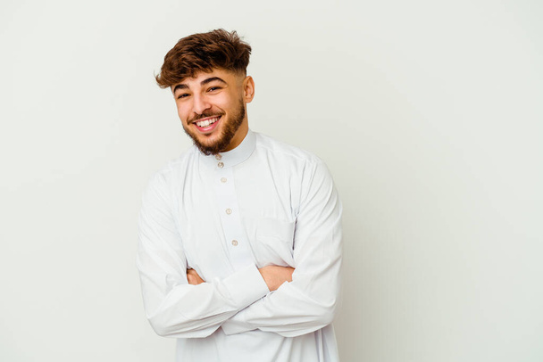 Young Moroccan man wearing a typical arab clothes isolated on white background laughing and having fun. - Photo, image