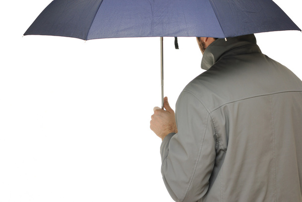 Man with an umbrella and raincoat isolated on white. - 写真・画像