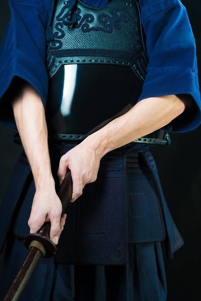 Hands with a wooden sword. Swordsman in uniform. Kendo fighter - Фото, изображение