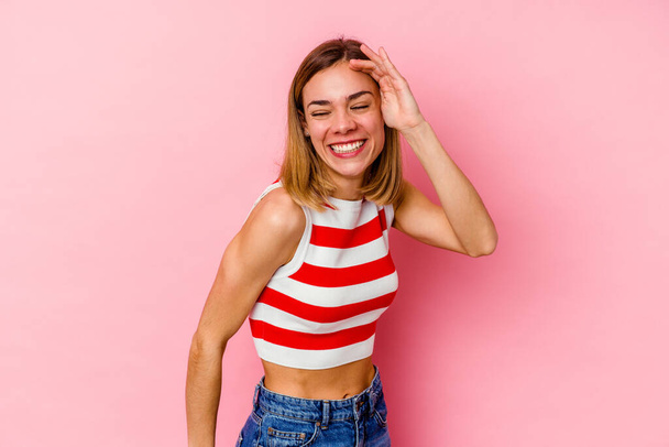 Young caucasian woman isolated on pink background joyful laughing a lot. Happiness concept. - Fotoğraf, Görsel