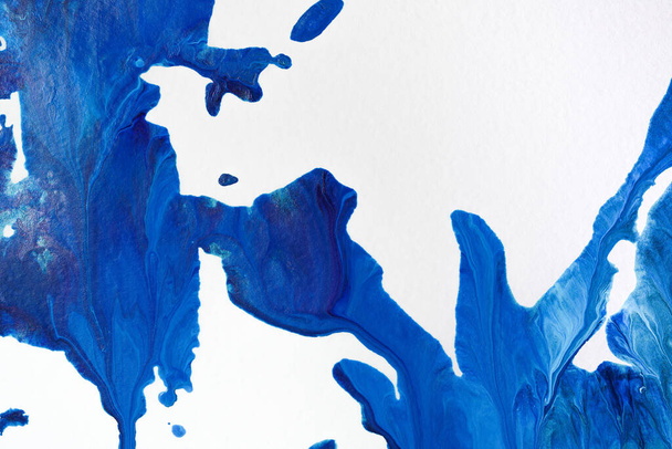 Blue acrylic paint on paper. Background made of stains of paint painted by hand - Φωτογραφία, εικόνα