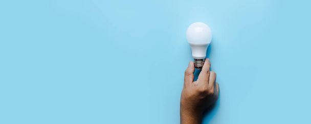Idea and creative innovation light bulb on blue background  - Photo, Image