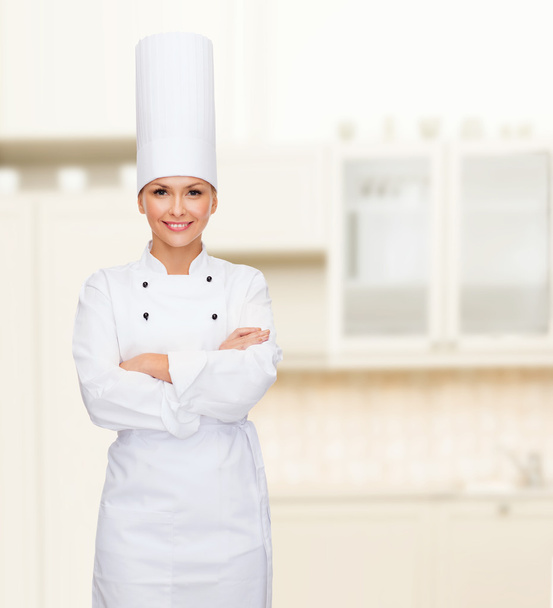 smiling female chef with crossed arms - Foto, Imagen