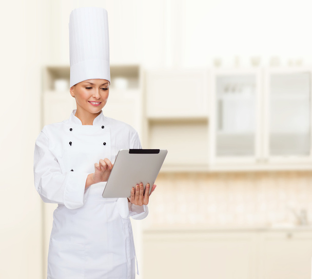 smiling female chef with tablet pc computer - Zdjęcie, obraz