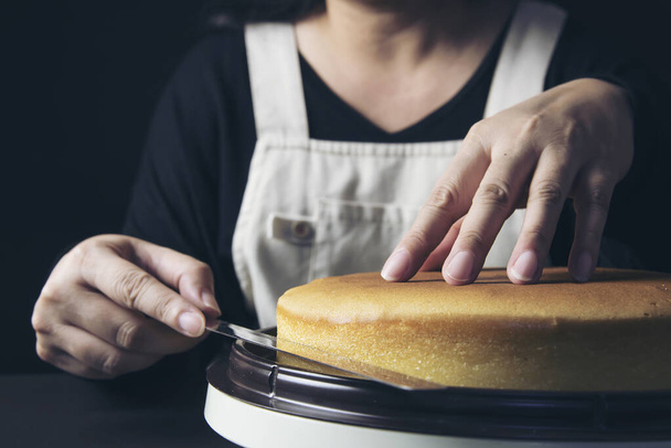 ケーキを作る女性はヘラを使ってクリームを作る-自家製ベーカリー料理のコンセプト - 写真・画像
