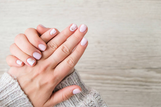 Closeup elegant pastel natural modern design manicure. Female hands. Gel nails. Nude manicure. Beige color. Skin care. Beauty. Nail care - Photo, image