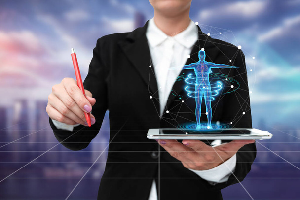 Lady In Uniform Standing Holding Tablet And Virtually Typing With Pen. Business Woman Carrying Pad Typing And Displaying New Futuristic Technologies. - Photo, Image