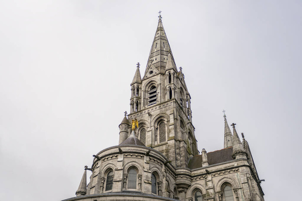 torens en gouden engel van de kathedraal van Cork in het zuiden van Ierland een typische grijze dag van het land - Foto, afbeelding