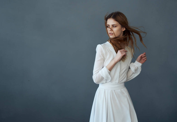 Woman in white dress posing on  isolated background. High quality photo - Photo, Image