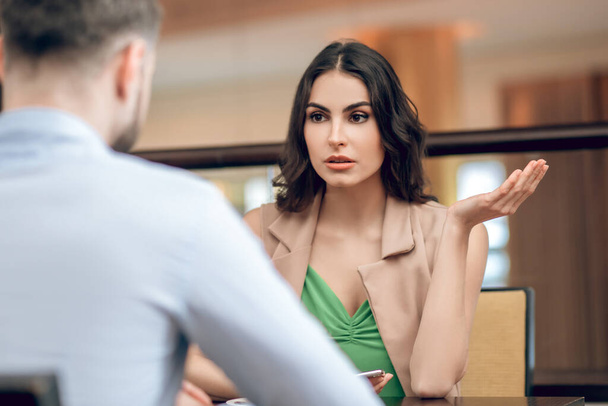 Young woman talking to a man and looking disappointed - Foto, Imagem