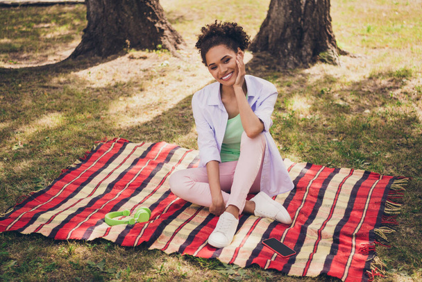 Full size photo of young attractive african woman happy positive smile sit plaid nature park relax weekend - Valokuva, kuva