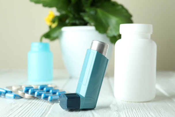 Asthma treatment accessories on white wooden table - Valokuva, kuva
