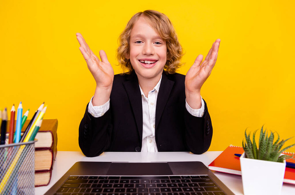 Portrait of positive handsome boy talking online education distance learning quarantine isolated on yellow color background - Foto, imagen