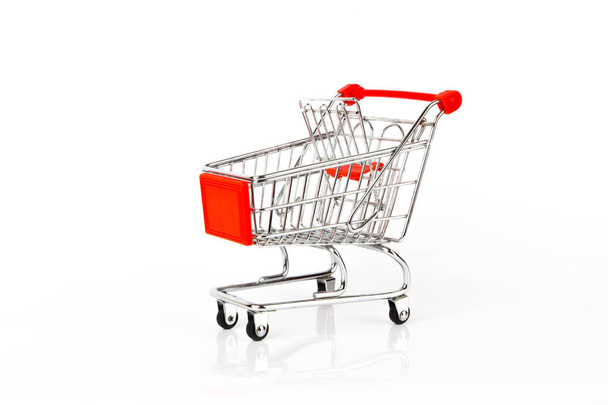Metal decorative shopping cart on the white glossy background, isolated - Foto, Imagen