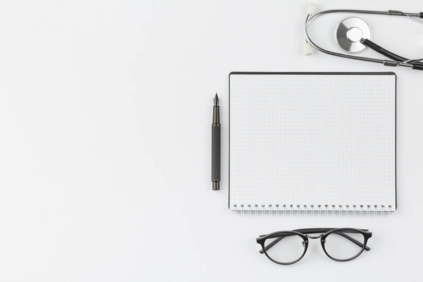 Notebook with stethoscope and glasses. - Foto, imagen