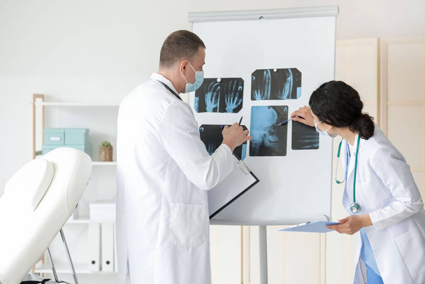 Doctors studying x-ray scans in clinic - Photo, Image