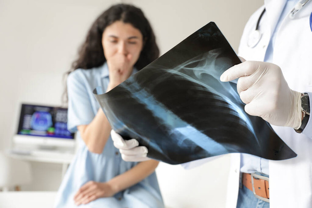 Mature doctor studying x-ray image of lungs in clinic, closeup - Photo, Image