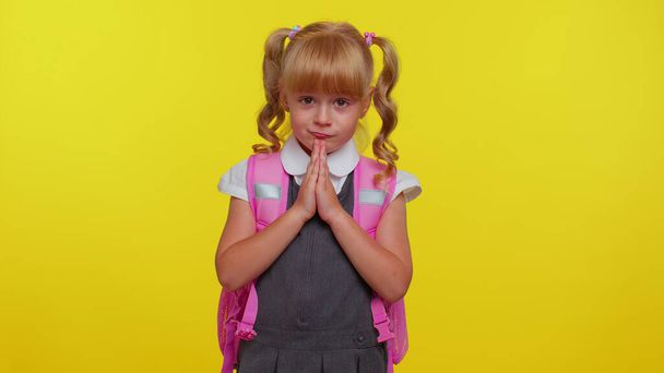 Teenage student girl kid in school uniform praying, looking upward and making wish, begging apology - Photo, Image
