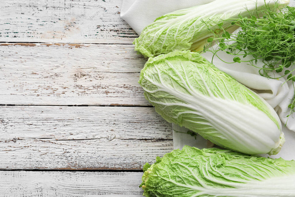 Fresh chinese cabbage on light wooden background - Foto, imagen