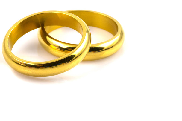 Primer plano de dos anillos de oro para boda aislados sobre fondo blanco - Foto, imagen