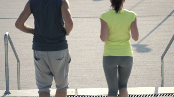 Couple jogging on stairs - Materiaali, video