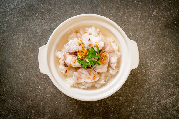porridge or boiled rice soup with fish bowl - Фото, зображення