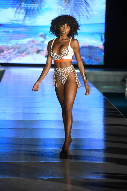 MIAMI BEACH, FLORIDA - JULY 10: A model walks the runway for Swim with poppies Show during Miami Swim Week The Shows powered by DCSW on July 10, 2021 in Miami Beach, Florida - Zdjęcie, obraz