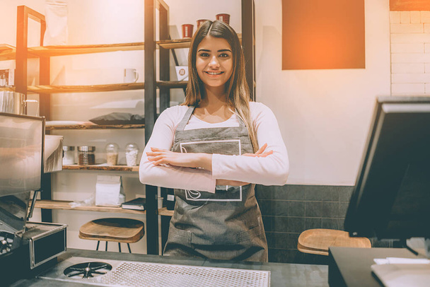The beautiful waitress standing behind the counter - Photo, Image