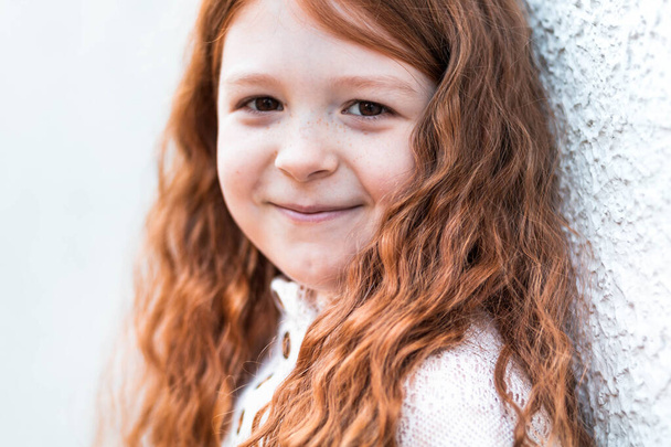 Close-up portrait of a cute, little, ginger girl - Fotoğraf, Görsel