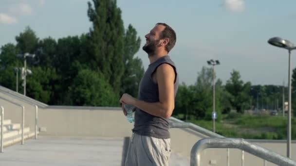 Jogger drinking water after run - Video