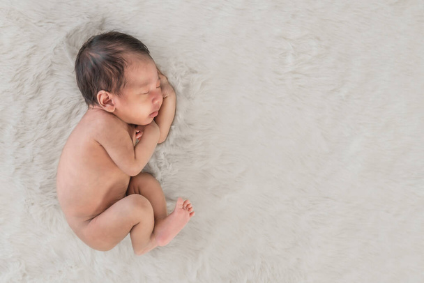 portrait of little newborn infant baby sleeping on white carpet - Photo, Image
