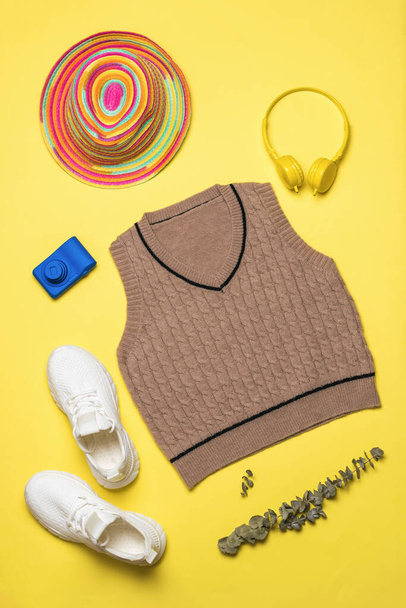 A set of stylish clothes and shoes on a yellow background. Fashionable classic knitted clothing. - Photo, Image
